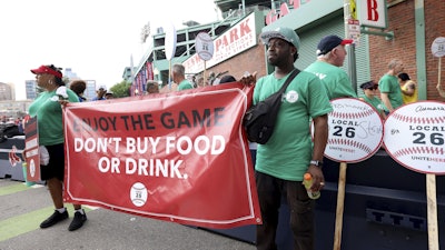 Concession workers from Fenway Park picket outside the ballpark Friday, July 25, 2025, in Boston before a baseball game between the Boston Red Sox and the Los Angeles Dodgers.