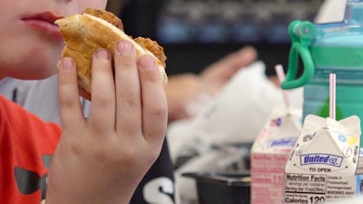 In this image from video, a student eats a meatball sub sandwich during lunch in Parkersburg, W.Va., on Wednesday, July 9, 2025.