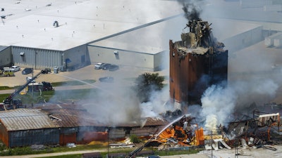 Firefighters battle a fire after an explosion in an industrial area in Fremont, Neb., Tuesday, July 29, 2025.