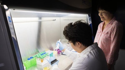 Binghamton PhD student Tianzheng Liu, left, and biomedical engineering professor Sha Jin have developed a method to turn food waste into biodegradable plastic.