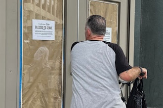 A man on a bicycle stops to read a sign posted at the entrance to Paula Deen's restaurant The Lady Sons in Savannah, Ga., Aug. 1, 2025.