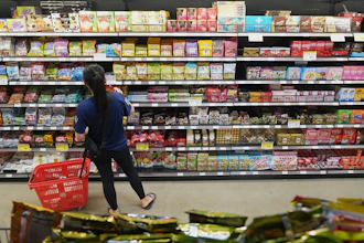 A customer buys Chinese made ginger candy at 99 Ranch Market, an Asian grocery store in Los Angeles, April 7, 2025.