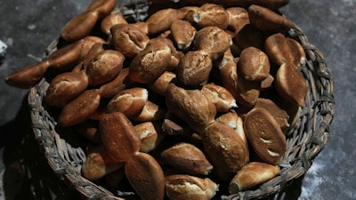 Freshly baked bread called 'pan de batalla,' or battle bread, which uses government subsidized flour, sits in a basket at a bakery in El Alto, Bolivia, Friday, Aug. 8, 2025.