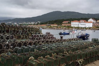 Octopus traps sit on the Port of Lira on Tuesday, June 24, 2025, in Lira, Spain, during an unusually long octopus fishing pause period.