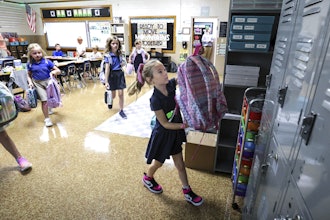 Savannah Knott hangs up her backpack for the day on the first day in her second grade classroom at Mary Carrico Catholic School, Tuesday, Aug. 12, 2025, in Knottsville, Ky.