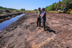 Cranberry grower Jarrod Rhodes points out to engineer Robert Kennedy, right, the path of water flow at a cranberry bog being restored to a natural habitat at the South Meadow Bogs, Thursday, Aug. 7, 2025, in Carver, Mass.