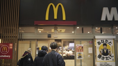 People stands outside a McDonald's store in Tokyo, March 15, 2024.