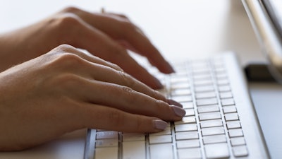 A person types on a keyboard on June 6, 2024, in Portland, Ore.