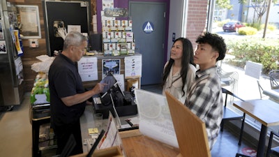 Braxton Kimura, right, orders food with his mother Carol Kimura at Vitality Bowl on Wednesday, Aug. 13, 2025, in San Jose, Calif.
