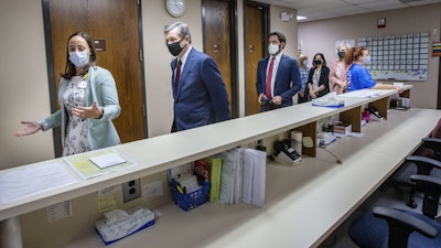 Health Director Lillian B. Koontz leads North Carolina Gov. Roy Cooper on a tour of the COVID-19 vaccine clinic at the Davidson County Health Department in Lexington, N.C., June 17, 2021.