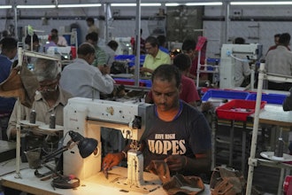 A worker stitches a footwear in a manufacturing unit in Agra, India, Monday, Aug. 25, 2025.