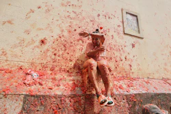 Revelers throw tomatoes at each other during the annual 'Tomatina' tomato fight fiesta, in the village of Bunol near Valencia, Spain, Wednesday, Aug. 27, 2025.
