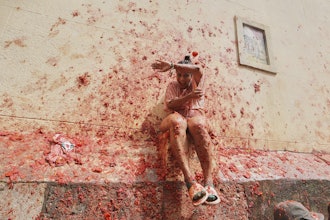Revelers throw tomatoes at each other during the annual 'Tomatina' tomato fight fiesta, in the village of Bunol near Valencia, Spain, Wednesday, Aug. 27, 2025.