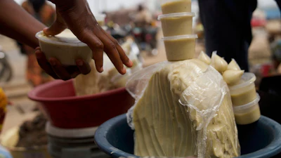 People buy shea butter on a street, in Abuja, Nigeria, Thursday, Aug. 28, 2025.