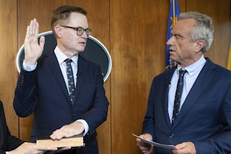 In this photo provided by the Department of Health and Human Secretary, Robert F. Kennedy, Jr., right, conducts the swearing-in ceremony of Jim O'Neill as the Department's Deputy Secretary, June 9, 2025, in Washington.