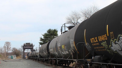 This image provided by the Howard Center for Investigative Journalism shows a train carrying tank cars, some containing hazardous materials, traveling across a railroad bridge in Paulsboro, N.J., on March 20, 2025, that was the site of a derailment and spill of toxic vinyl chloride in 2012.