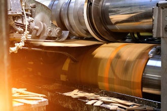 Ready-made cardboard boxes are moved in stacks along an automated packaging line.
