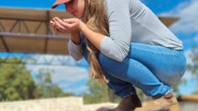 Luiza Braga smells Arara coffee beans during drying after anaerobic fermentation.
