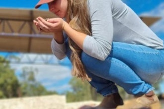Luiza Braga smells Arara coffee beans during drying after anaerobic fermentation.