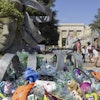 Plastic items are seen next to an artwork by Canadian artist and activist Benjamin Von Wong, titled 'The Thinker's Burden', a 6-meter-tall sculptural remix of Rodin's iconic Thinker, created especially for the Plastics Treaty negotiations, on Place des Nations in front of the European headquarters of the United Nations in Geneva, Switzerland, Monday, Aug. 4, 2025 before the second segment of the fifth session of the Intergovernmental Negotiating Committee on Plastic Pollution (INC-5.2).