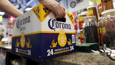 A customer places a case of Corona Extra on the checkout counter for purchase at Susquehanna Beer and Soda in Marysville, Pa, April 1, 2010.