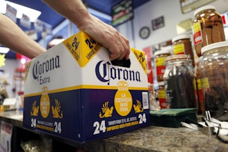 A customer places a case of Corona Extra on the checkout counter for purchase at Susquehanna Beer and Soda in Marysville, Pa, April 1, 2010.