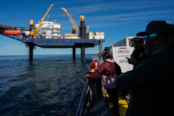Expedition 501 members look down from the Liftboat Robert platform, to the approaching Gaspee, a crew transport vessel, in the North Atlantic, Saturday, July 19, 2025.