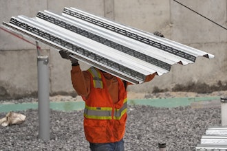 A construction worker carries steel decking at the site of a construction of a housing project, Thursday, July 31, 2025, in Portland, Maine.