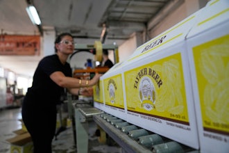 Nadin Khoury, 36, packs Taybeh beer products on a production line of the family's Taybeh Brewery Co. in the West Bank town of Taybeh, Sept. 6, 2025.