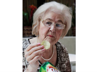 Marilyn Hagerty samples a Lays potato chip during an interview with the Associated Press in New York, March 14, 2012.