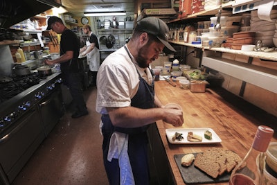 Chef Jake Vatalaro sprinkles locally foraged locust flower seasoning on a Chef's Meze Plate, which includes locally foraged mushrooms, at the Black Trumpet restaurant, Tuesday, Sept. 16, 2025, in Portsmouth, N.H.