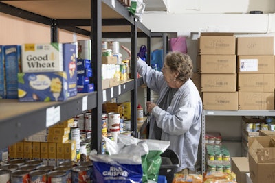 Phylis Allen organizes supplies at Neighbor's Cupboard in Winterport, Maine, on Tuesday, Aug. 26, 2025, a food pantry that she has helped run for the past 17 years.