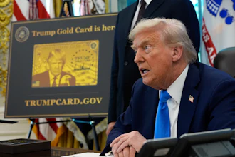 A poster showing the Trump Gold Card is seen as President Donald Trump signs executive orders in the Oval Office of the White House, Friday, Sept. 19, 2025, in Washington.