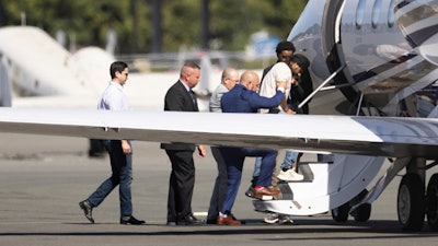 Harjinder Singh is escorted onto an airplane by Florida Lt. Gov. Jay Collins and law enforcement, Aug. 21, 2025, Stockton, Calif.