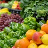 Fruits and vegetables lined up at a grocery store.