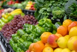 Fruits and vegetables lined up at a grocery store.