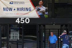 A hiring sign is displayed at a post office in Schaumburg, Ill., Sept. 18, 2025.