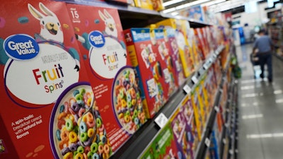 A customer walks past a display of Great Value brand cereal at a Walmart Neighborhood Market, Friday, Sept. 26, 2025, in Bentonville, Ark.