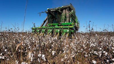 A cotton picker moves through Chris Hopkins' cotton field, Dec. 6, 2024, near Lyons, Ga.