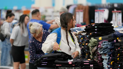 A worker stocks a display of clothing at a Sam's Club, Sept. 24, 2025, in Bentonville, Ark.