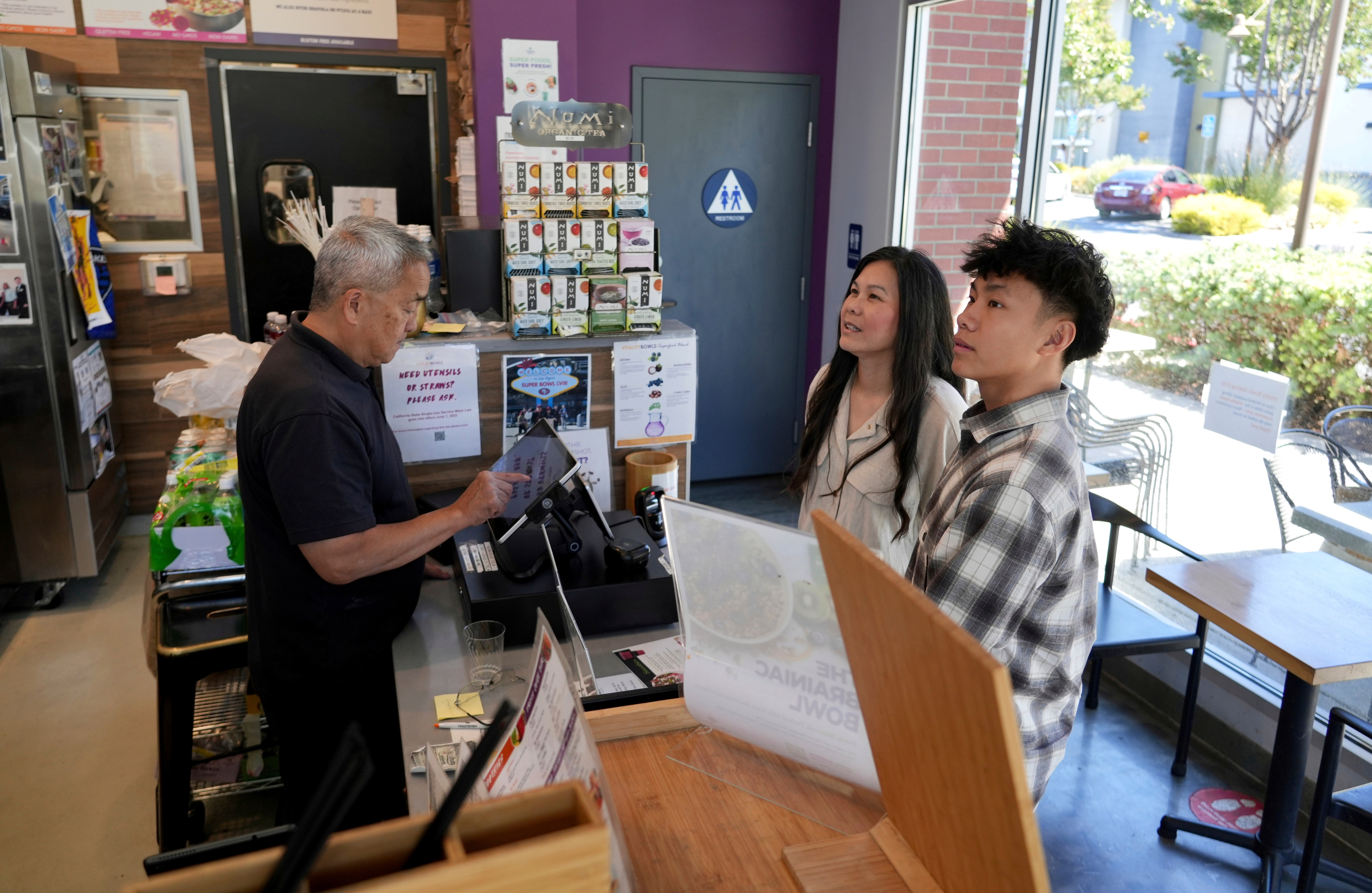 Braxton Kimura, right, orders food with his mother Carol Kimura at Vitality Bowl on Aug. 13, 2025, in San Jose, Calif.