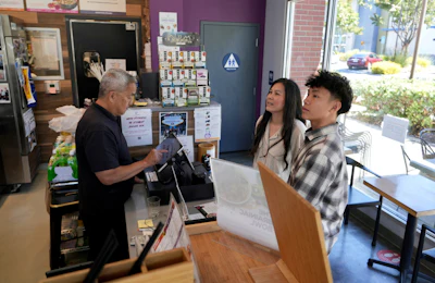 Braxton Kimura, right, orders food with his mother Carol Kimura at Vitality Bowl on Aug. 13, 2025, in San Jose, Calif.