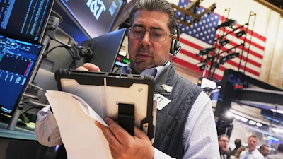 Trader Michael Capolino works on the floor of the New York Stock Exchange, Wednesday, Oct. 15, 2025.