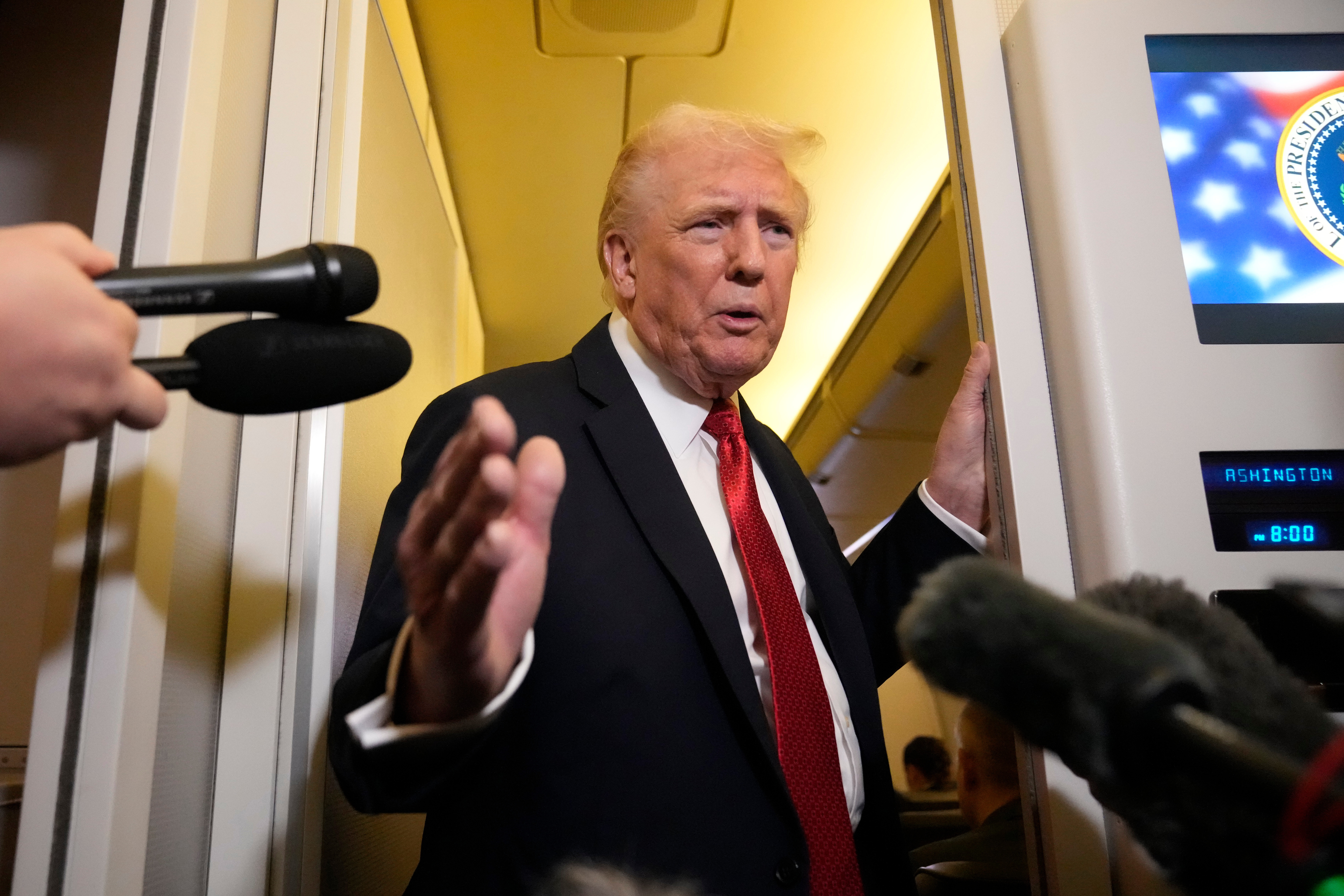 President Donald Trump speaks to reporters aboard Air Force One, Sunday, Oct. 19, 2025, en route to Joint Base Andrews, Md., as he returns from a trip to Florida.