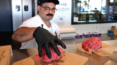 Nate Abeyta, owner and founder of Deep Cuts butcher shop, prepares an order of ground meat for a customer, Tuesday, Oct. 21, 2025, in Dallas.