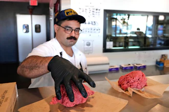 Nate Abeyta, owner and founder of Deep Cuts butcher shop, prepares an order of ground meat for a customer, Tuesday, Oct. 21, 2025, in Dallas.