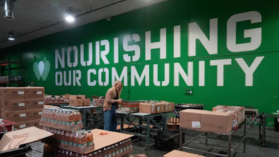 Mara Sleeter, marketing and communications project manager, stands near boxes of juice while being interviewed in the San Francisco-Marin Food Bank warehouse in San Francisco, July 2, 2025.