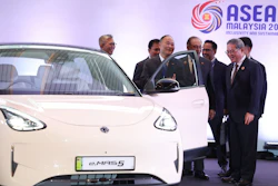 Chinese Premier Li Qiang, right, reacts as he, along with Malaysian Prime Minister Anwar Ibrahim, center, inspects a car produced by Malaysia's national automaker, Proton, in which China's Zhejiang Geely Holding Group holds a 49.9% stake, ahead of the signing ceremony for the ASEAN–China Free Trade Area 3.0 Upgrade and the ASEAN–China summit, held as part of the ASEAN summit in Kuala Lumpur, Malaysia Tuesday, Oct. 28, 2025.