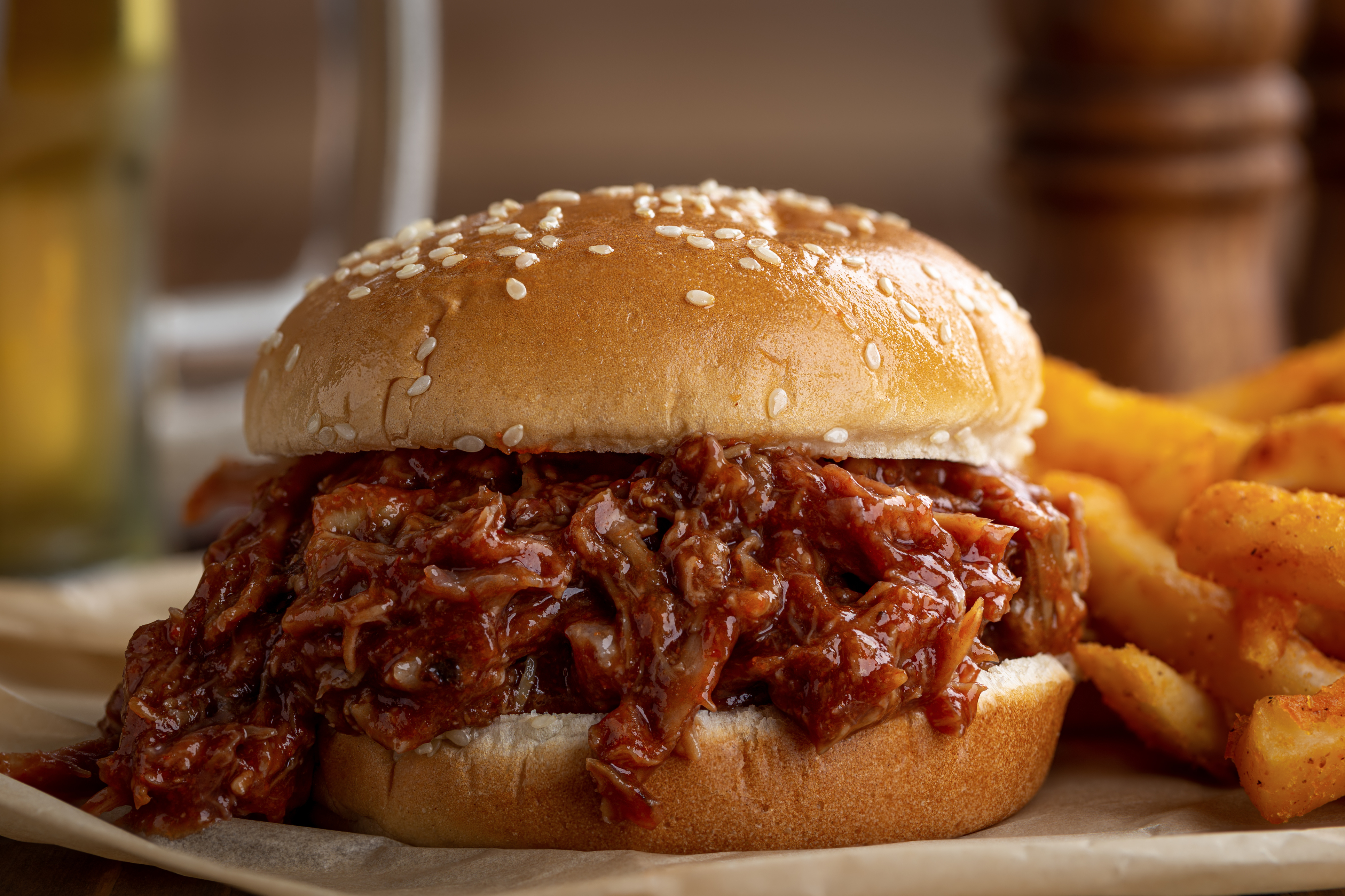 Barbecue pulled pork sandwich with a sesame bun.