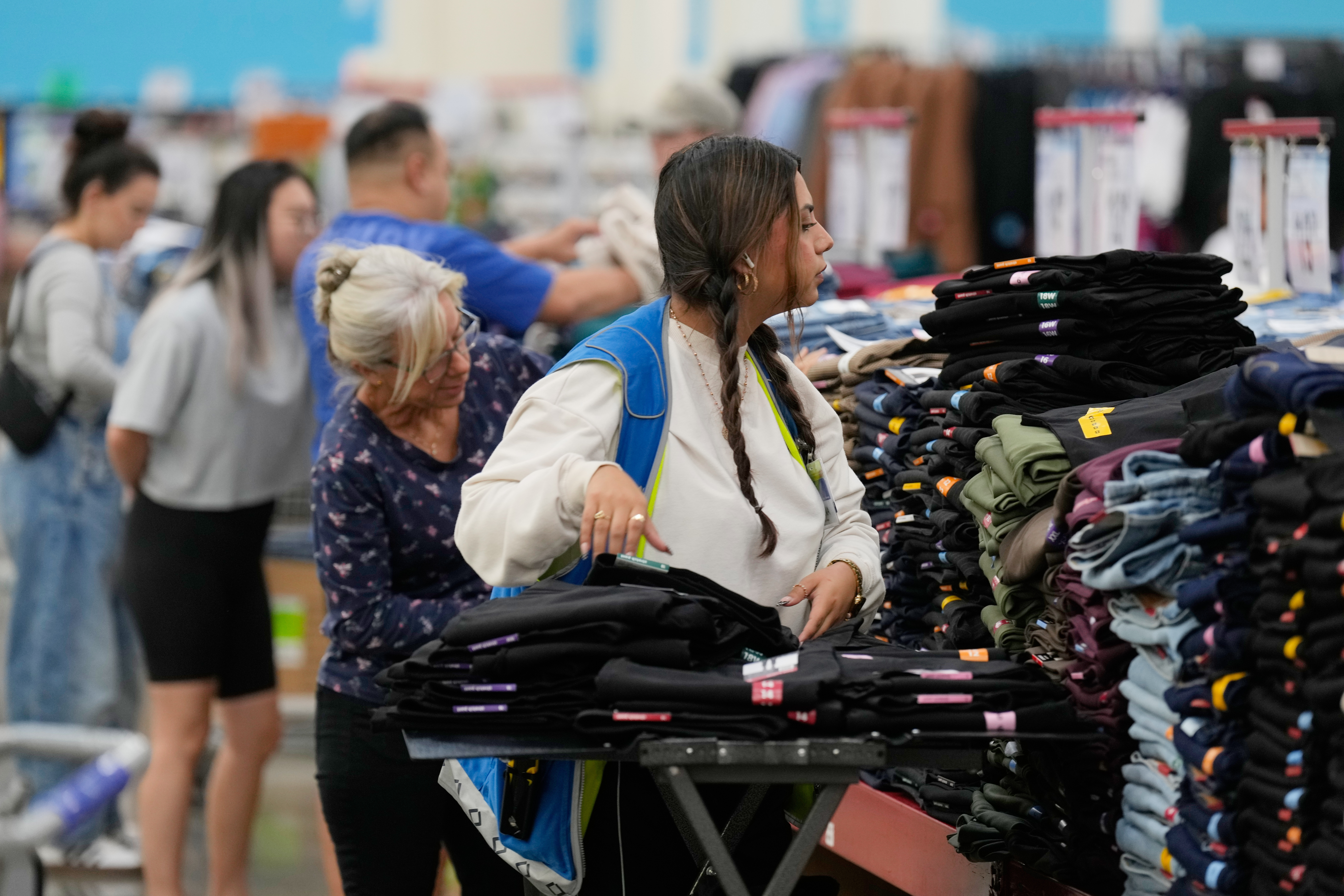 A worker stocks a display of clothing at a Sam's Club, Sept. 24, 2025, Bentonville, Ark.